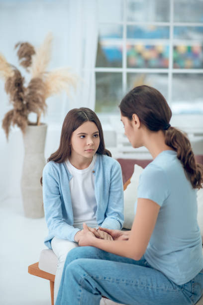 istock Upset daughter looking at mom sitting next to her 1305514129