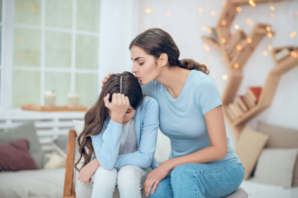 istock Loving mom carefully hugging her upset daughter 1305514133