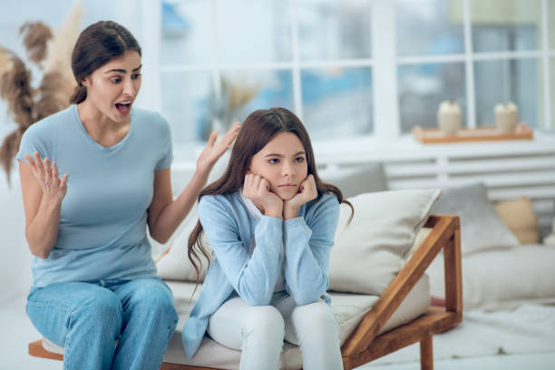 istock Emotional screaming mom and turned away daughter 1305514135