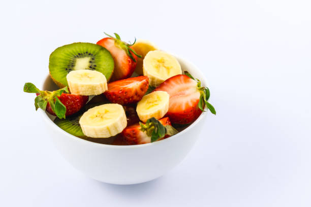 istock A fruit salad cut into a white bowl on a white background 1305515654