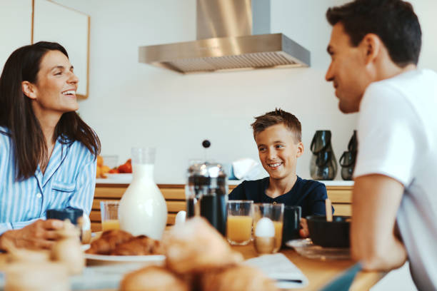 istock Smiling family having breakfast together 1305516612