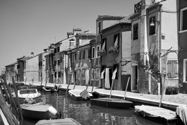 Canal in Burano in Venice, Italy. Black and white photography, italian cityscape