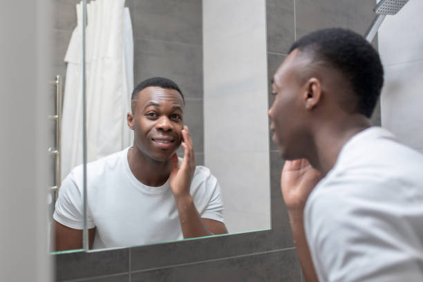 istock African american young handsome man looking at himself in the mirror 1305517351