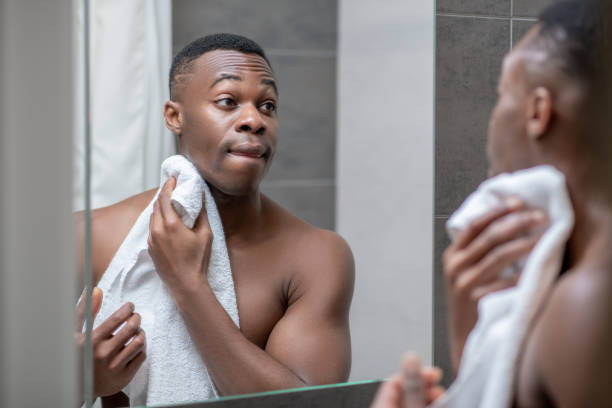 istock African american young handsome man holding a towel 1305517356