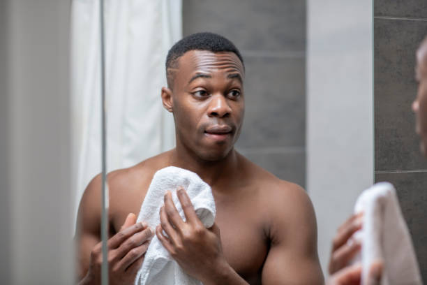 istock African american young handsome man holding a towel 1305517361