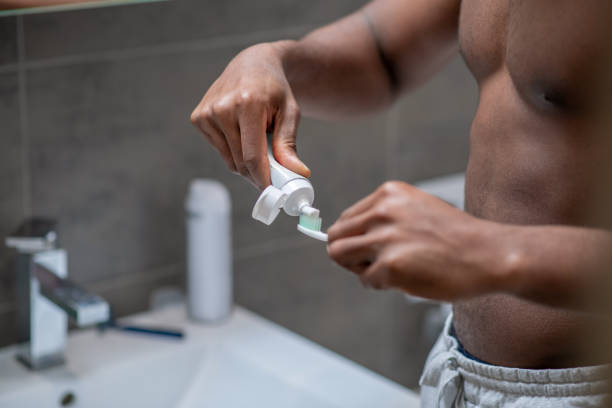 istock Close up of mans hands with a toothbrush 1305517384