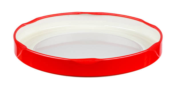 istock Inverted bright red tin screw cap for glass jar isolated on white background 1305519831