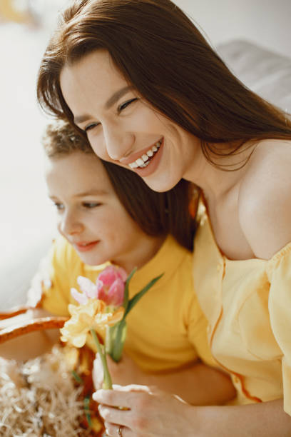 istock Mother and son inspect Easter eggs and put them in a basket 1305520156