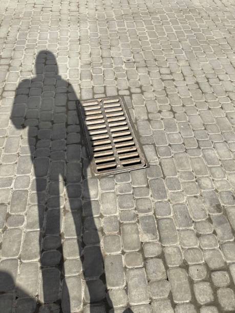 istock shadow of a man on asphalt 1305520194