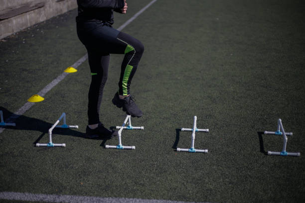 istock Athlete stepping over mini hurdles stock photo 1305521051