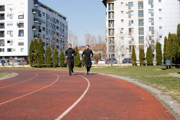 istock Two young friends training outdoors. stock photo 1305521340