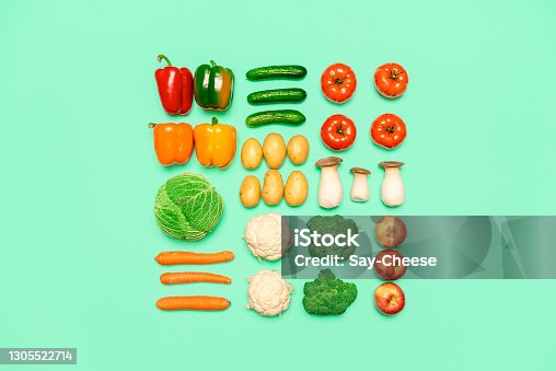 istock Vegetables and fruits symmetry, isolated on a colored background, top view. Healthy food concept 1305522714