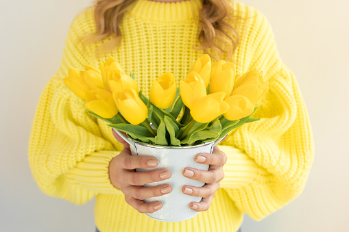bouquet of yellow tulips in girls hands care womens day holiday concept caucasian