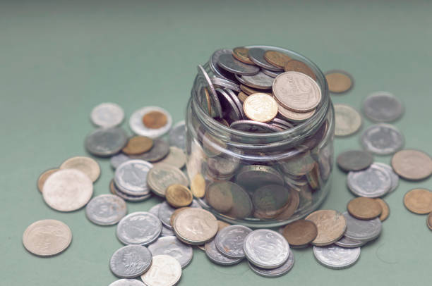 istock Saving Money in a Glass Jar 1305527526