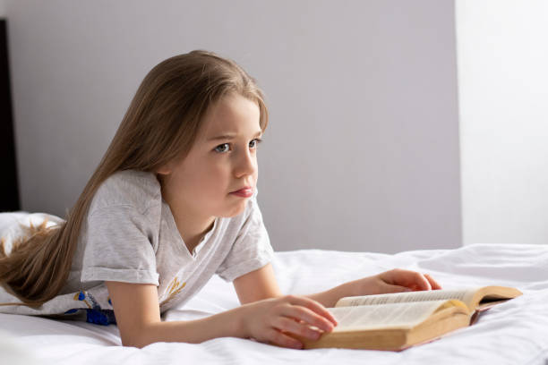 istock girl thinking and reading a book 1305527869