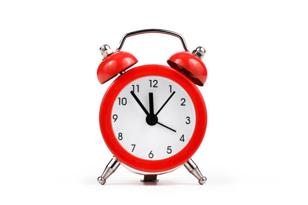 istock Red retro style alarm clock on white background 1305533275