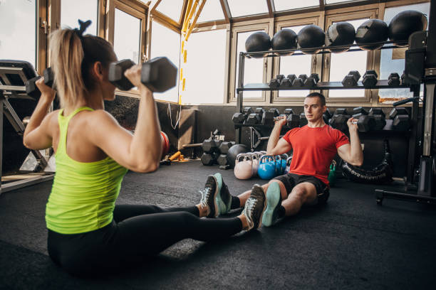 istock Man and woman exercising together 1305534252