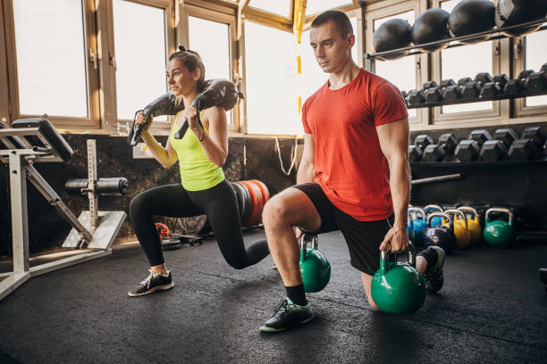 istock Man and woman exercising together 1305534399