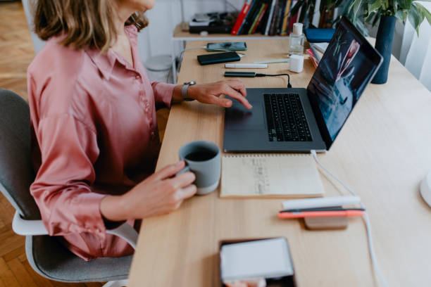 istock Anonymous Senior Woman Sitting in her Home Office and Using her Laptop Computer 1305535855