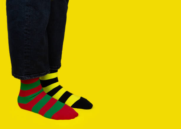 istock Legs with different stripes socks on background with copy space. World Down syndrome day background. Down syndrome awareness concept. 1305537491