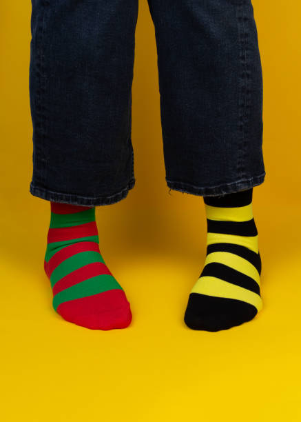 istock Legs with different stripes socks on background with copy space. World Down syndrome day background. Down syndrome awareness concept. 1305537495