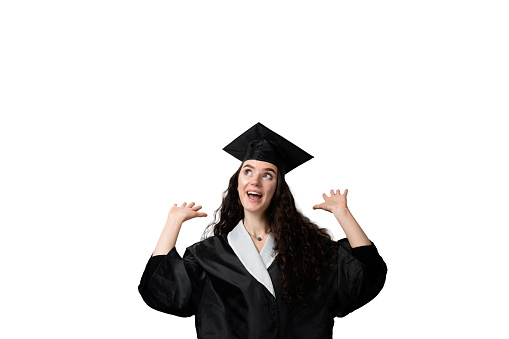 Graduate girl with master degree in black graduation gown and cap on white background. Happy young woman careerist have success in her business.