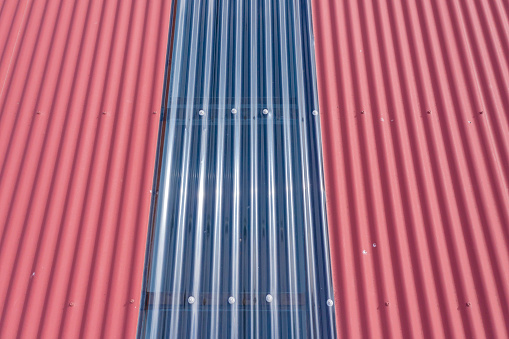 Aerial view of burgundy coloured corrugated iron and perspex roof panels