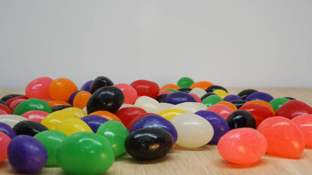istock Colorful jelly beans spread out on board 1305544599