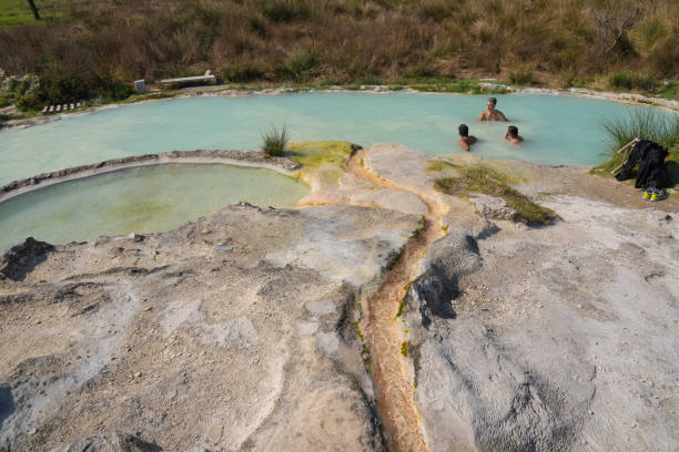 people bathing in pool of thermal spring carletti in viterbo, lazio, spain - waterfall health spa man made landscape imagens e fotografias de stock