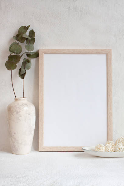 istock Blank sheet in a photo frame on the table. Mock up in a trendy style. 1305547441