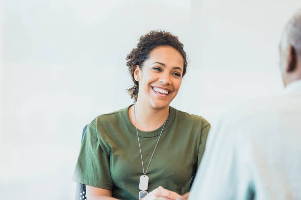 istock Confident female veteran talks with financial advisor 1305552371