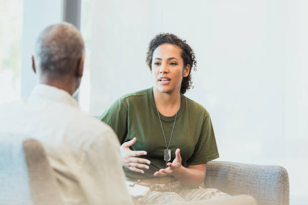 istock Vulnerable soldier talks with mental health professional 1305552395