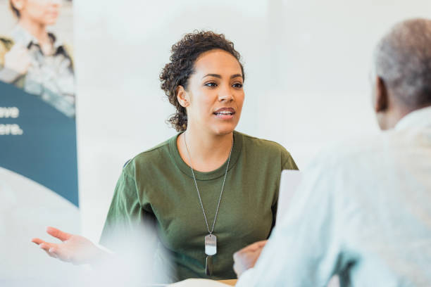istock Female soldier gestures while explaining financial situation to banker 1305552413