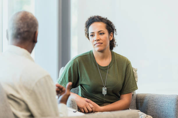 istock As therapist speaks, soldier's face shows anger 1305552439