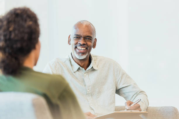 istock Unrecognizable client and male counselor share laugh 1305552474