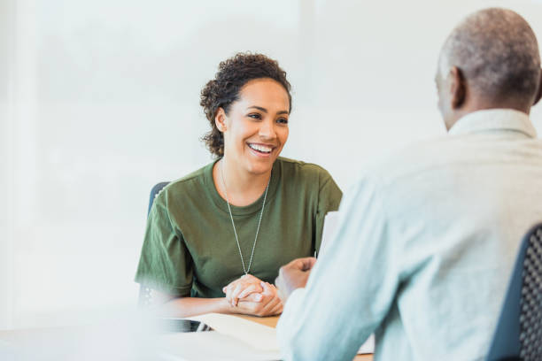 istock Female soldier smiles at unrecognizable senior financial advisor 1305552500