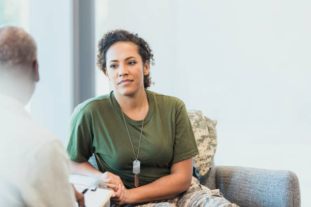 istock Female soldier is upset with unrecognizable therapist 1305552524