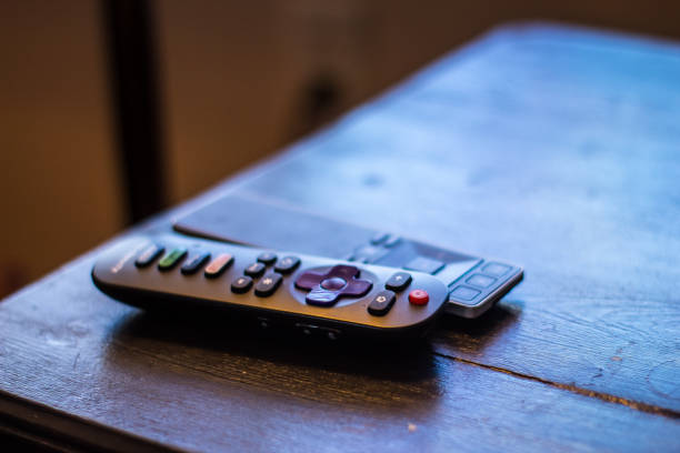 Television remotes on black table. Television remotes on black table. remote control on table stock pictures, royalty-free photos & images