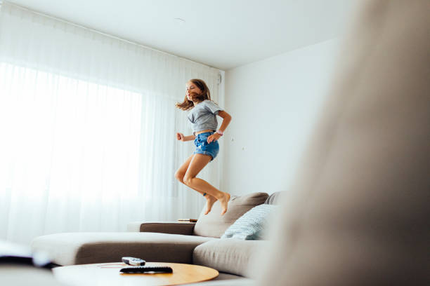 istock Young Girl playing on sofa 1305561383