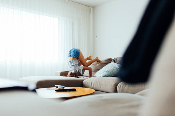 istock Young Girl playing on sofa 1305561416