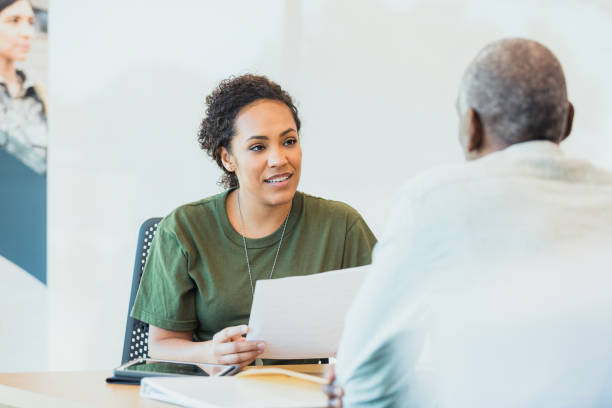istock Female soldier holds document while listening to banker 1305563691