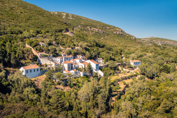 View of the Arrábida Convent (16th century) in the Arrábida Natural Park near Setúbal in Portugal, on a summer day. The Arrábida Convent or Nossa Senhora da Arrábida Convent was built in the 16th century on the southern side of the Serra da Arrábida. It was a Franciscan convent.
It is currently integrated in the Arrábida Natural Park. setúbal city portugal stock pictures, royalty-free photos & images