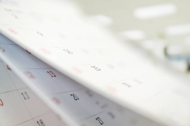 istock Calendar page flipping sheet close up on office table interior background business schedule planning appointment meeting concept 1305568078