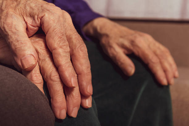 istock Elderly marriage couple. Close up aged hands. 1305568282