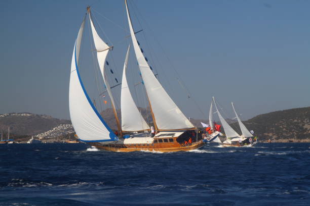 gulet wooden sailboats - sailboat storm teamwork competition stock-fotos und bilder