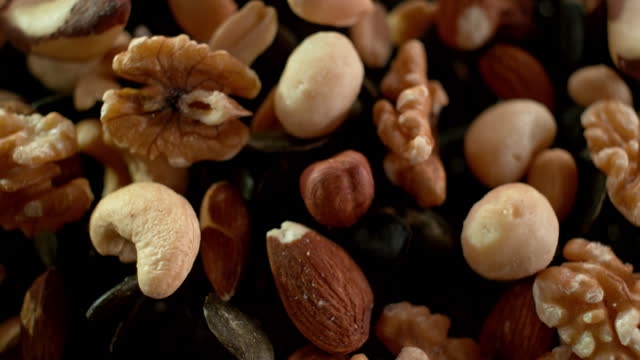 SLO MO LD A mix of nuts and seeds bouncing into the air