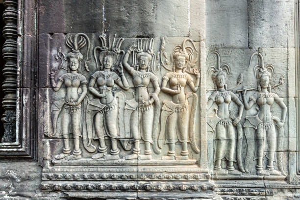 Siem Reap, Cambodia - January 20, 2020: Deep relief of dancing Apsaras at Angkor Wat temple, Cambodia. The Angkor Wat is a Hindu temple complex in Cambodia and is the largest religious monument in the world.