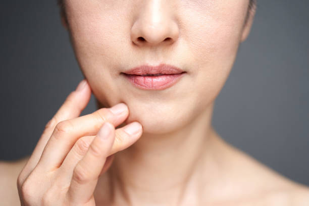 Middle-aged Japanese woman worried about wearing a cheek stick Middle-aged Japanese woman worried about wearing a cheek stick drooping photos stock pictures, royalty-free photos & images