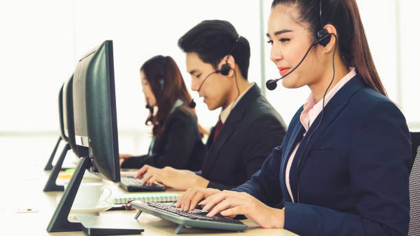 istock Business people wearing headset working in office 1305574751