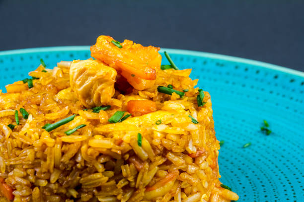 istock spanish paella dish with seafood, rice and chicken Top view 1305574945